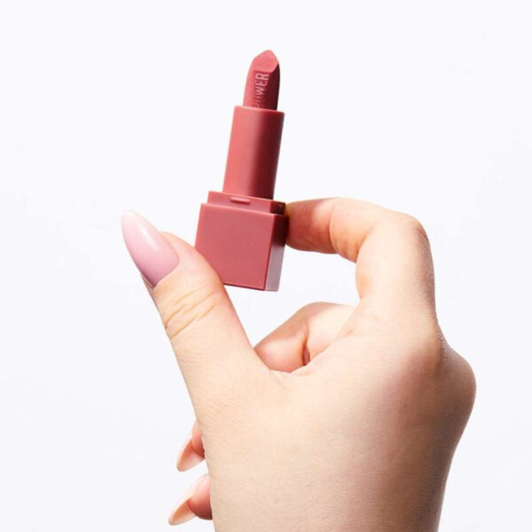 "Swatches of Huda Beauty Power Bullet Mini Lipstick with bold, pigmented colors on various skin tones."