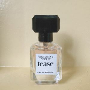 "Victoria’s Secret Tease mini perfume displayed with floral and lace props"

