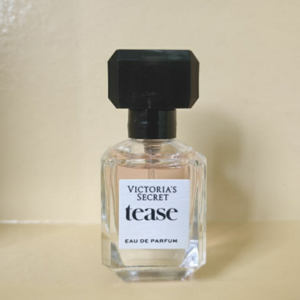 "Victoria’s Secret Tease mini perfume displayed with floral and lace props"